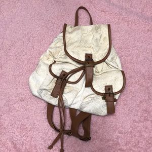 white and brown backpack